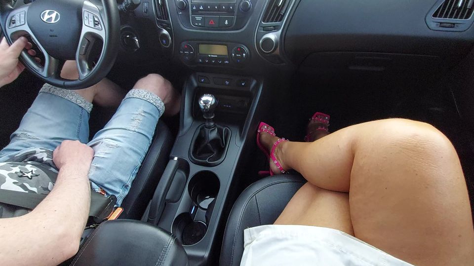 Elegant mature woman in a short skirt and high heels in a taxi in the morning