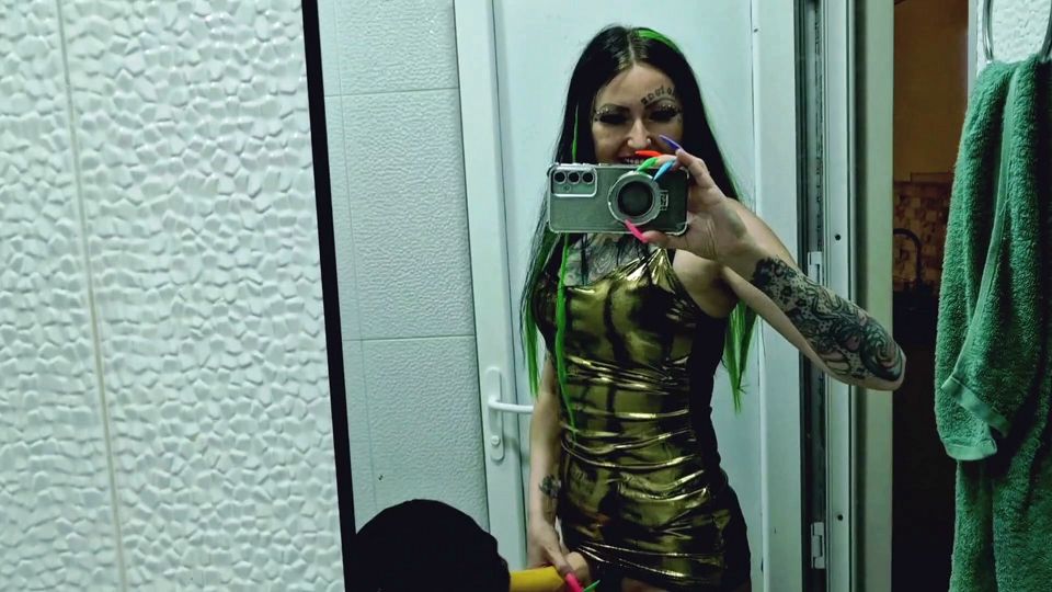 A slave is cleaning a dirty toilet when Dominatrix Nika comes to him with a strap-on and makes him take the strap-on in his mout