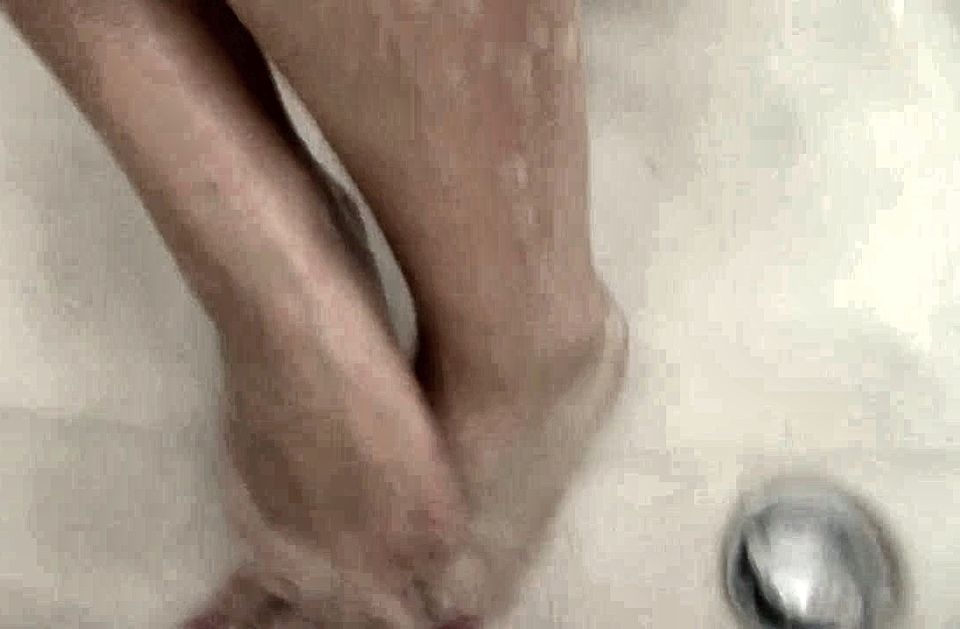 Naughty teen cleans her feet in the bathtub for your pleasure